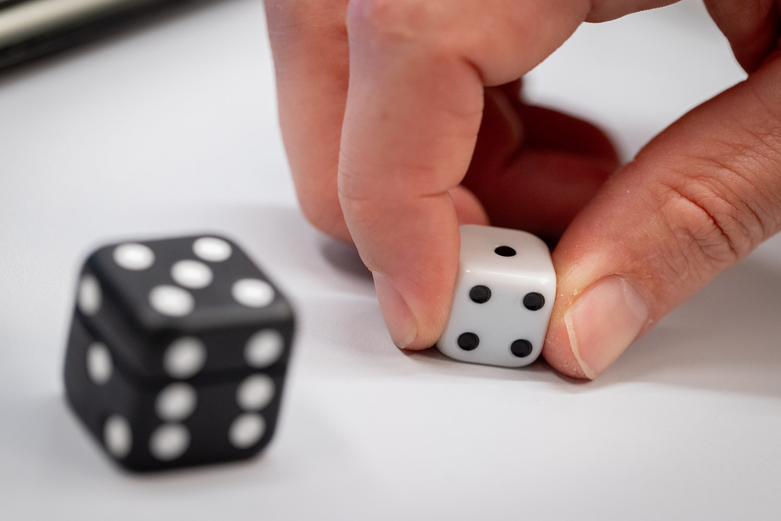 Bobo Balance A person rolls a dice in their hand