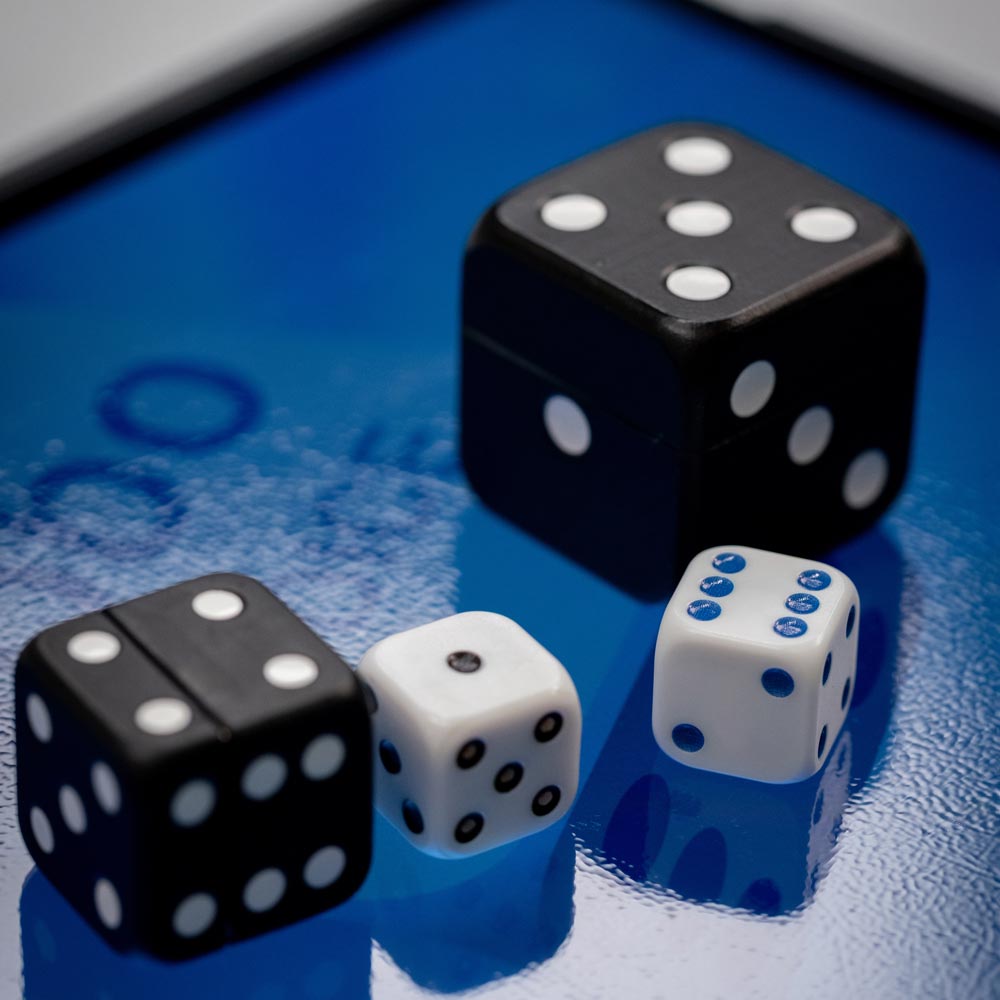 VAVO0305 Three dice and a smartphone on a table